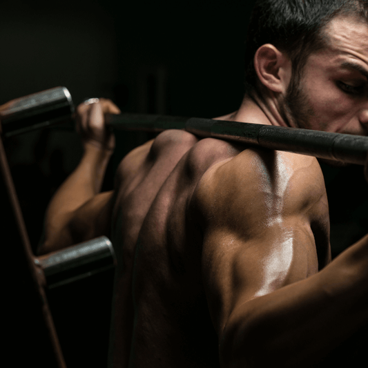 A man using a squat rack for strength training, showcasing the Ideal Squat Rack for Your Home Gym.