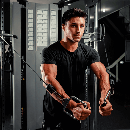 The Essential Guide to Functional Trainers: person using a functional trainer machine for strength training in a gym.